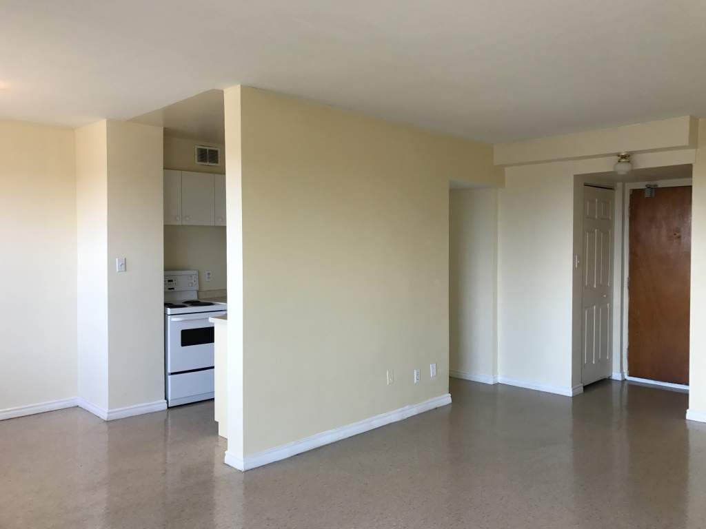 A room with a white oven and a white dishwasher.