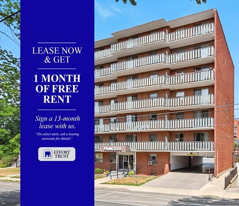 A large brick building with a sign offering a free month of rent.