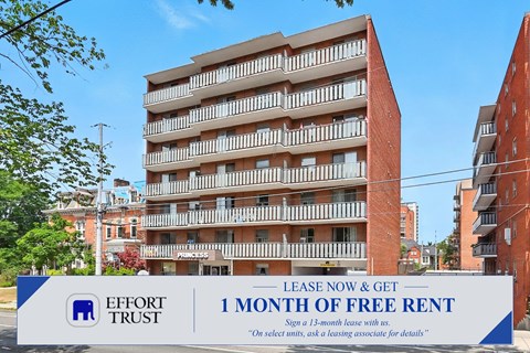 A large building with a sign offering a free month of rent.