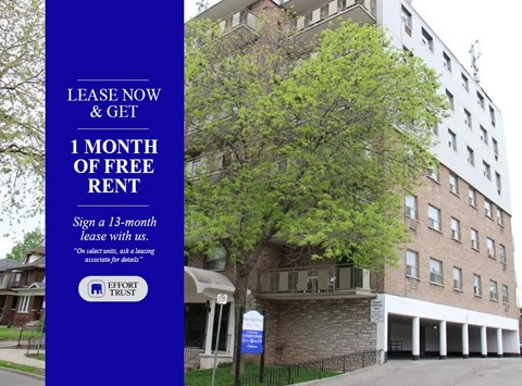 A building with a sign offering a free month of rent.