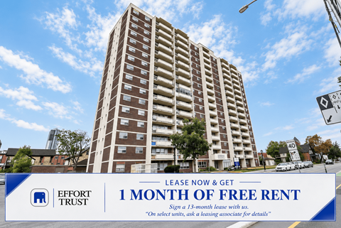 A tall building with a sign offering 1 month of free rent.