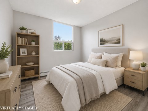 A bedroom with a large bed, a nightstand, and a bookshelf.
