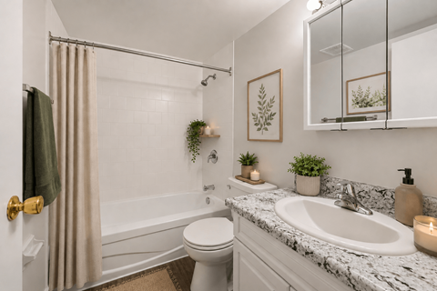 A bathroom with a white toilet, a white sink, and a white bathtub.