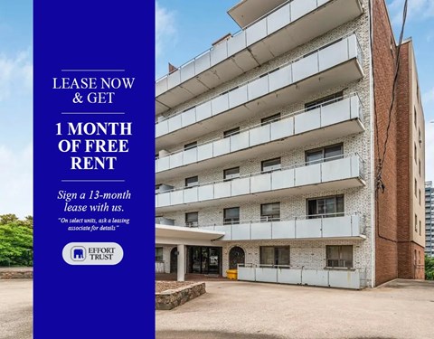 A building with a sign offering a free month of rent.