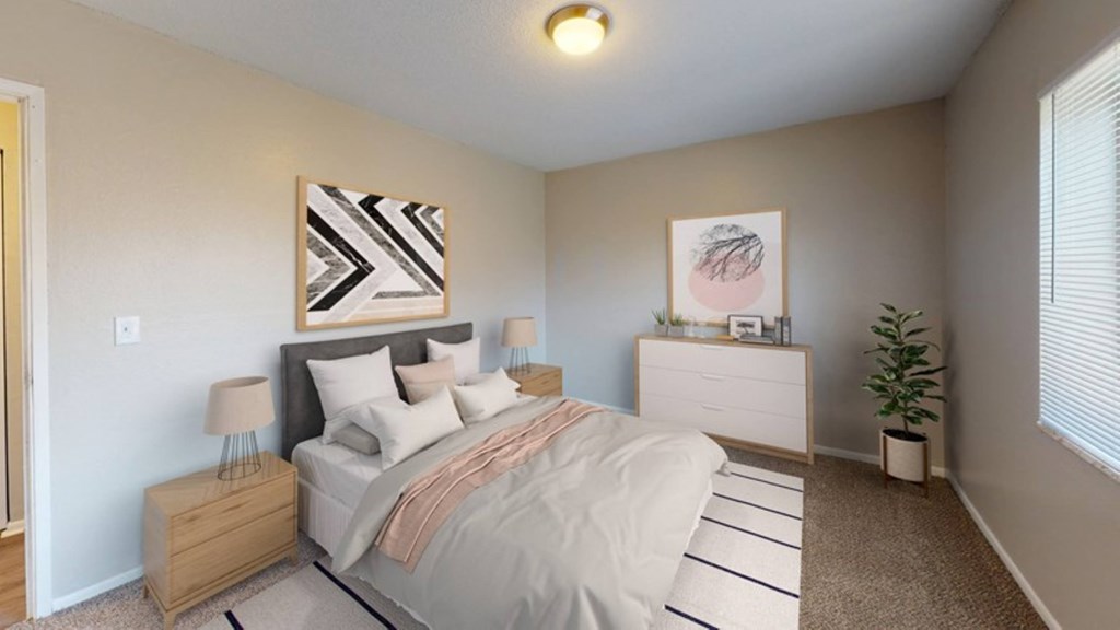 A bedroom with a bed, dresser, nightstand, and lamp.