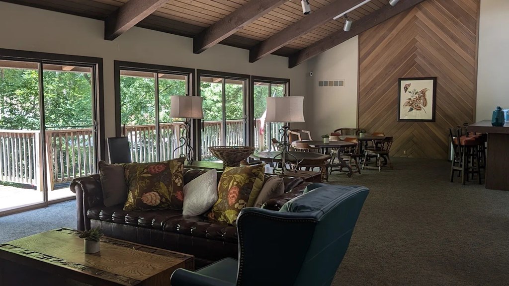 A living room with a couch, chairs, and a coffee table.