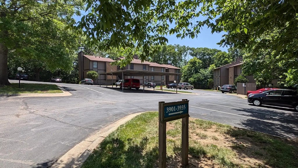 Parking lot for an apartment complex with a sign in front