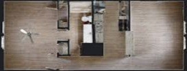 A top view of a room with a bed, a desk, and a chair.