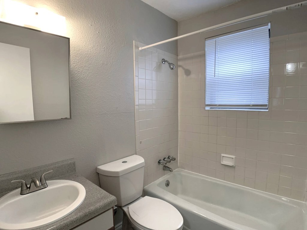 A bathroom with a toilet, sink, and shower. A bathroom with a toilet, sink, and shower.