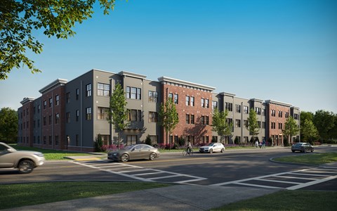A street view of a row of townhouses with cars parked in front.