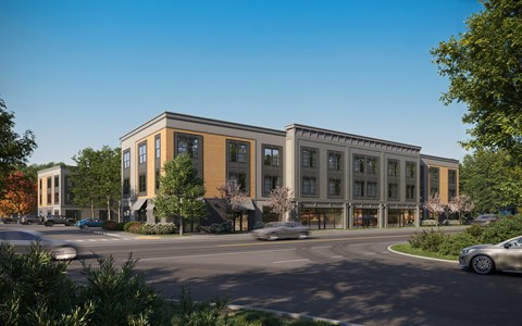 A modern building with a parking lot in front.