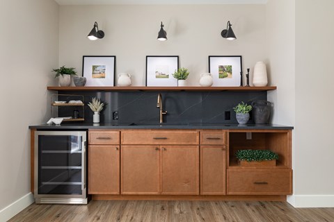 A kitchen with wooden cabinets and a black countertop.