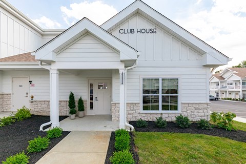 A white building with the words "CLUB HOUSE" on the front.
