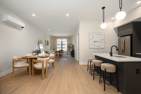 A modern kitchen with a dining table and chairs.