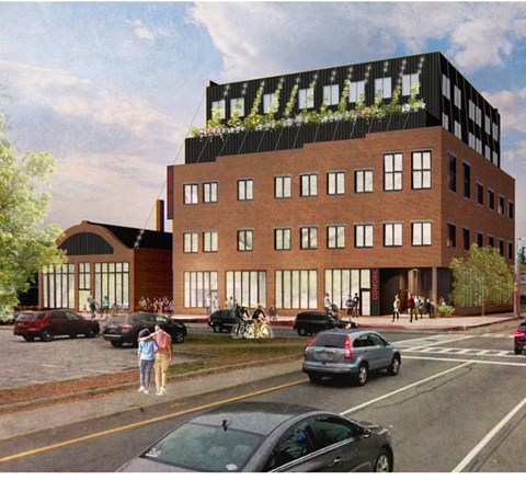 A modern building with a green roof is depicted in the image.
