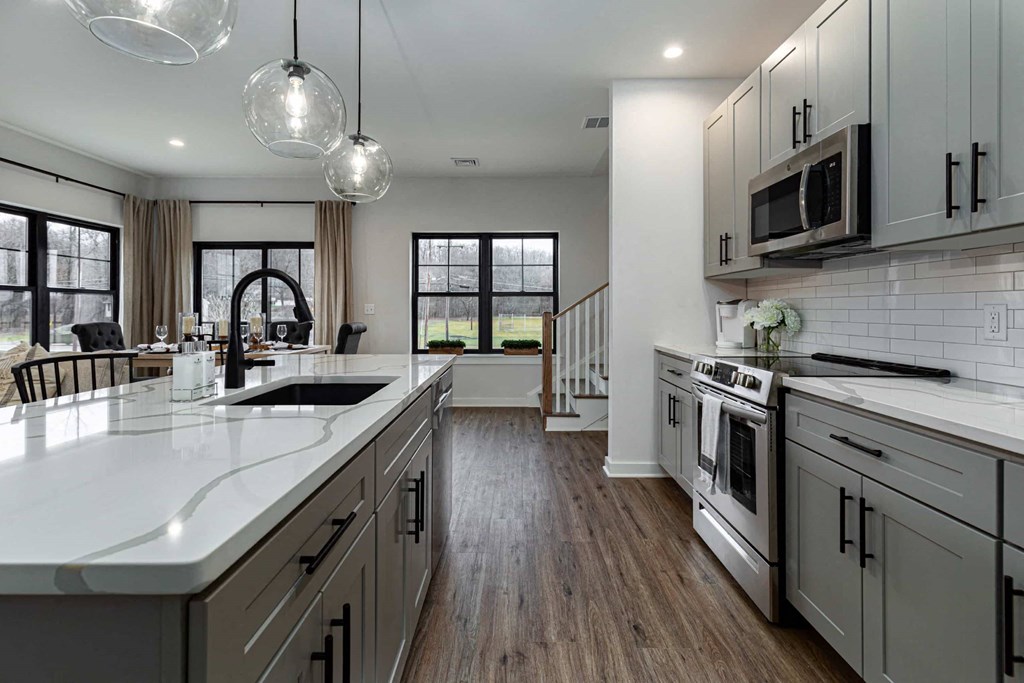 A modern kitchen with a large island and stainless steel appliances.