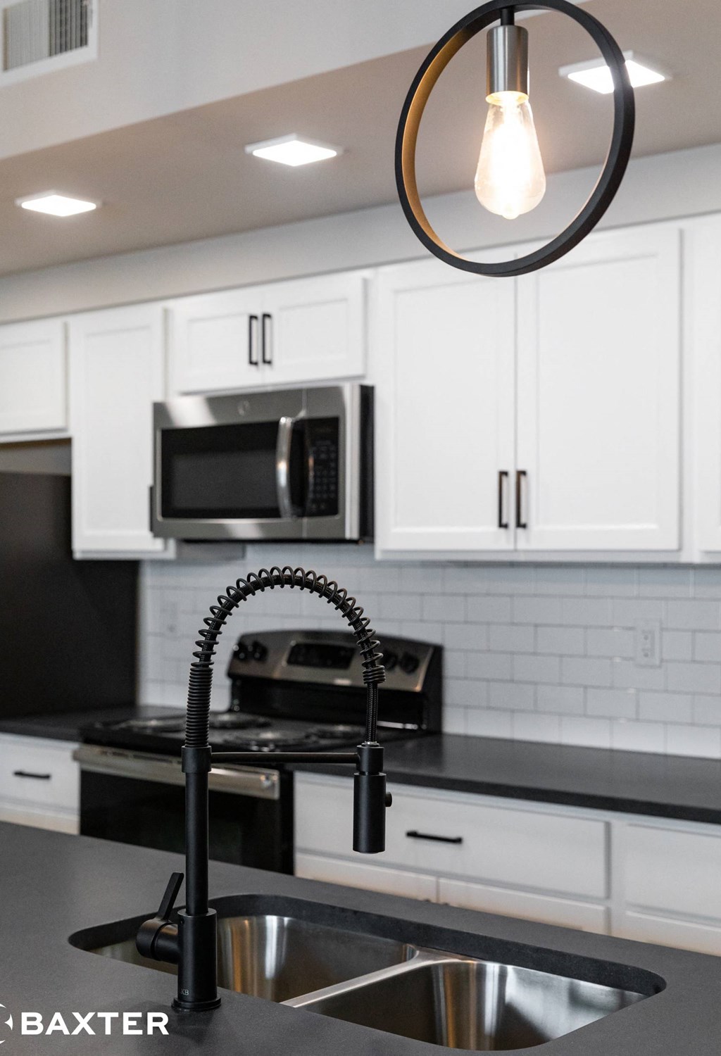 A modern kitchen with a black and white color scheme.