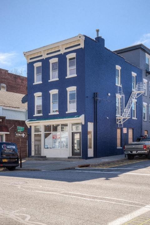 A blue building with a white ladder on the side.