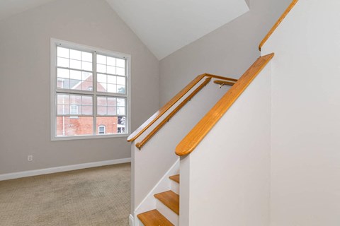 A room with a staircase leading to a window.