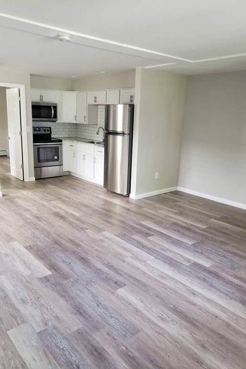 A kitchen with a stove top oven and a refrigerator.