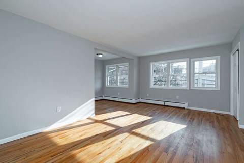 A room with wooden floors and white walls.