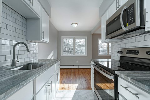 A modern kitchen with a black stove top oven.