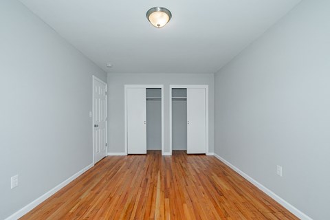 A room with wood floors and white walls.
