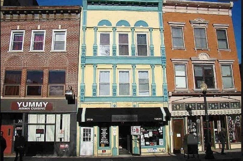 A row of buildings with Asian cuisine restaurant on the left.