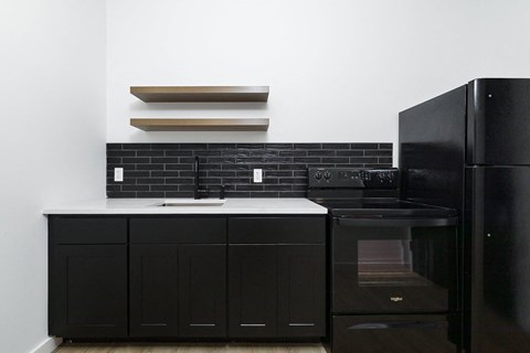 A black oven and cabinet in a kitchen.