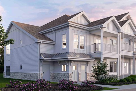 A large, two-story house with a balcony on the upper floor.