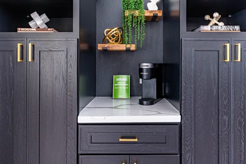 A kitchen with dark wood cabinets and a white countertop.