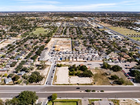 A large construction site is surrounded by a residential area.