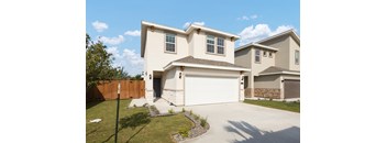 A two-story house with a white garage door.