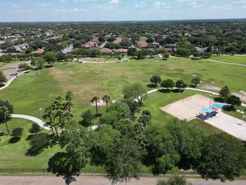 A park with a basketball court and a playground.
