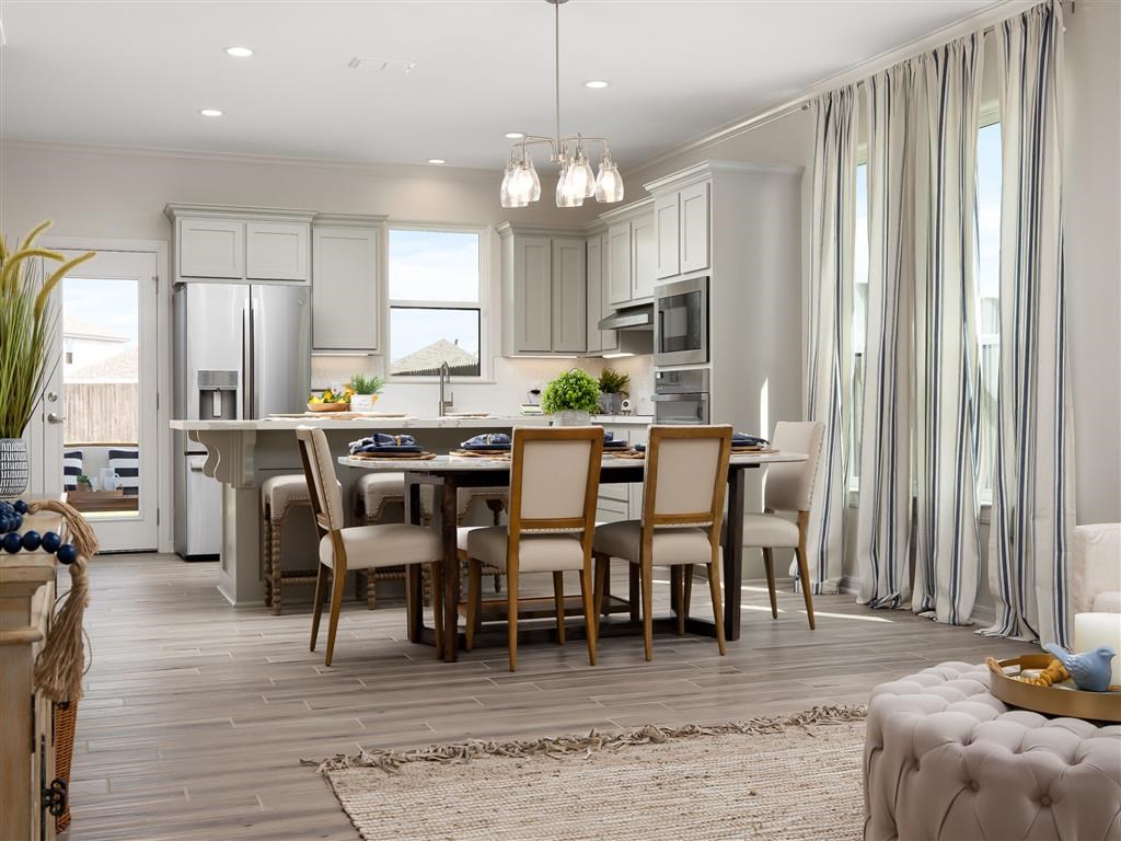 A modern kitchen with a dining table set for four.