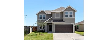 A two-story house with a garage door and a tree in front.