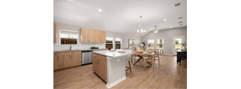 A kitchen with a table and chairs in the middle of the room.