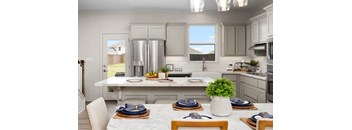 A kitchen with a table set for a meal.