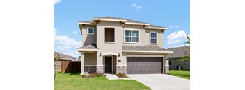 A two-story house with a garage door and a driveway.