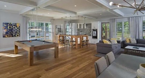 A pool table is in the middle of a living room.