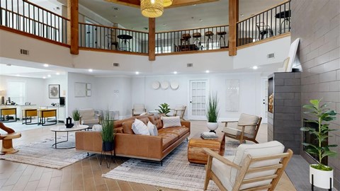 A living room with a brown couch and a fireplace.