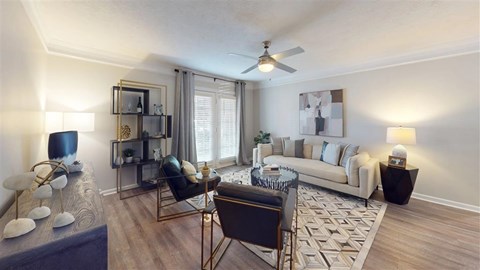 A living room with a black chair and a white couch.