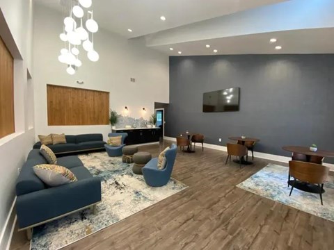 A modern living room with a blue sofa and wooden furniture.
