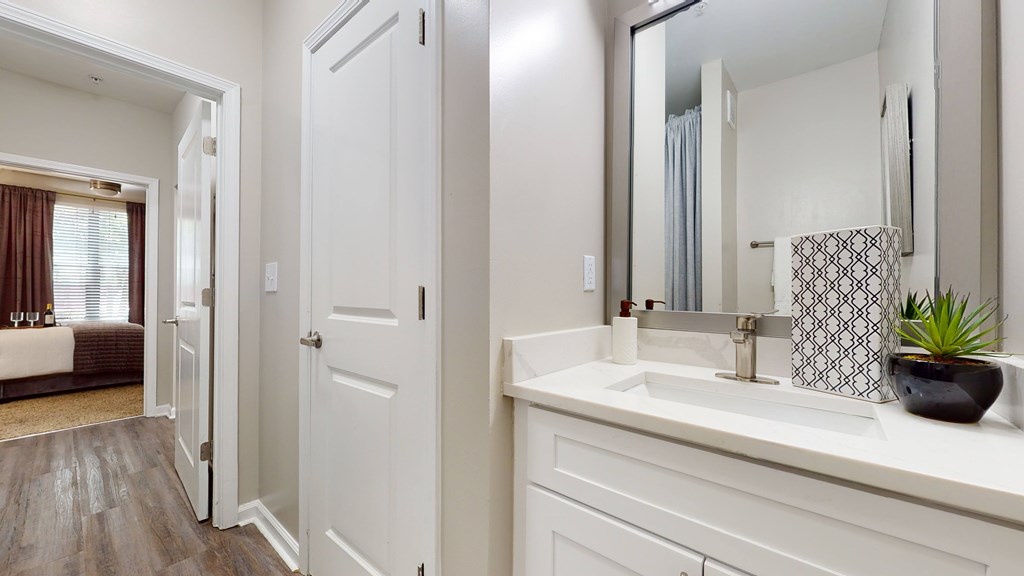 A bathroom with a white sink and a mirror at Embry Hills, Atlanta, 30042