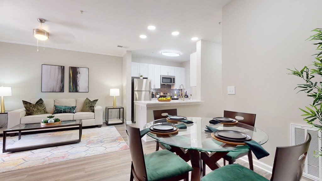 A modern dining room with a glass table and green chairs at Embry Hills, Atlanta, GA