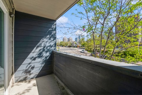 A balcony with a view of a cityscape and trees. at Oak Center Apartments, Oakland, CA, 94607
