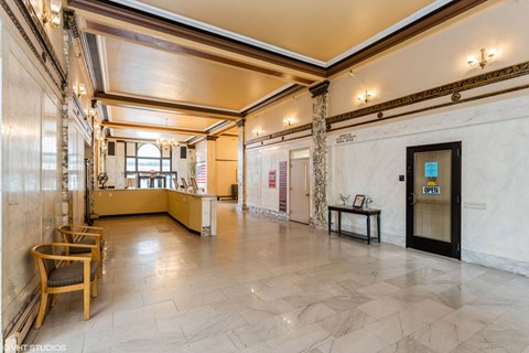 A spacious room with a wooden floor and a large window. A spacious room with a wooden floor and a large window at Mohican Apartments, New London