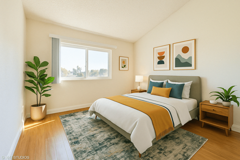 A bedroom with a bed, nightstand, and a plant at Oak Center Apartments, Oakland