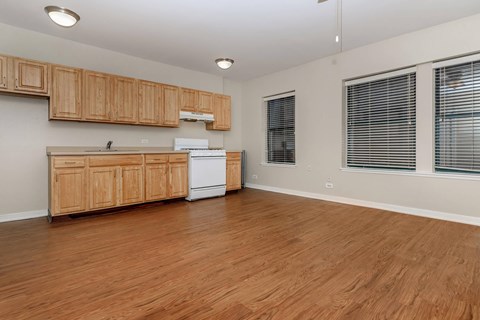 A kitchen with wooden cabinets and a white fridge.
