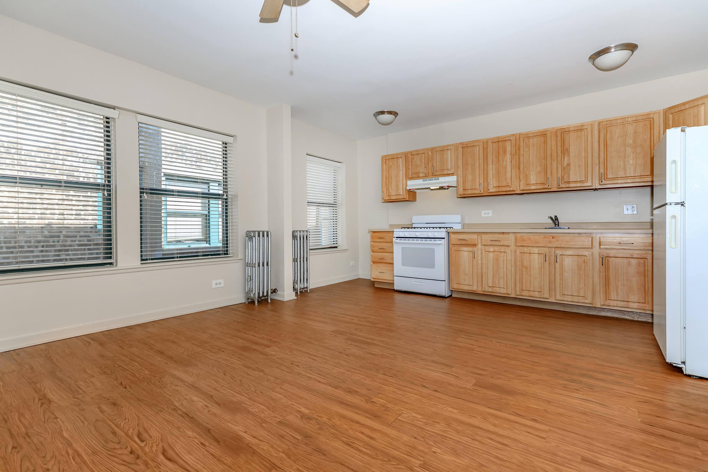 A kitchen with wooden cabinets and a white refrigerator.